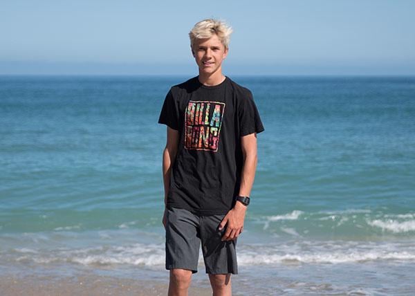 Photo of team rider Tommy Coleman standing in front of the ocean