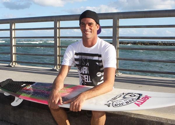 Photo of team rider Randy Townsend sitting with surfboard on lap