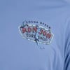 Close-up of a blue shirt featuring a Cocoa Beach Ron Jon Surf Shop logo with a blue tentacle wrapping around part of the sign.