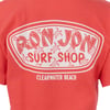 Back of a red t-shirt showing a Ron Jon Surf Shop logo with turtle graphics and Clearwater Beach text underneath.