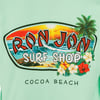 Green shirt featuring Ron Jon Surf Shop logo with a tropical scene, flowers, and Cocoa Beach text.