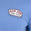 Close-up of a blue t-shirt with a Ron Jon Surf Shop, Ocean City, MD logo printed on the chest.