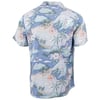 Back view of a short-sleeve shirt featuring a tropical island print with palm trees, flowers, waves, and surfers in blue, white, and pastel colors.