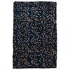 A rectangular piece of fabric with a dark blue background and a brown leafy pattern.