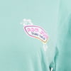 Close-up of a teal T-shirt featuring a small Ron Jon Surf Shop logo with a hibiscus flower design on the left chest area.