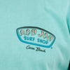 Turquoise shirt with Ron Jon Surf Shop, Cocoa Beach logo printed on it.