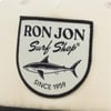 Patch logo with RON JON Surf Shop, a shark illustration, and Since 1959 text on a light fabric background.