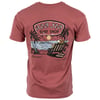 A red t-shirt with a Ron Jon Surf Shop Cocoa Beach graphic showing a dog relaxing in a chair by the ocean under palm trees at sunset.