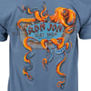 Blue t-shirt featuring an orange octopus wrapping its tentacles around a sign that reads Ron Jon Surf Shop Cocoa Beach, FL.