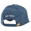 Blue baseball cap with KEY WEST embroidered on the back in white. Adjustable strap with a metal clasp.