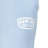Close-up of a light blue fabric featuring a white Ron Jon Surf Shop logo printed on it.
