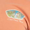 Close-up of an orange shirt with a Ron Jon Surf Shop logo featuring palm trees and the text Cocoa Beach, Florida.
