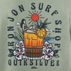 Graphic design on a shirt showing a woman on an orange slice in a drink, surrounded by flowers and ocean waves. Text reads Ron Jon Surf Shop Quiksilver.