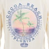 Long-sleeve shirt with a circular design of two palm trees and a coastal sunset. Text reads Cocoa Beach, Florida, Paradise, Since 1959. Logo says Ron Jon Surf Shop.