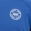 Close-up of a blue garment featuring a circular Ron Jon Surf Shop logo with wavy lines and Est. 1959 text.