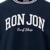 Close-up of a navy blue shirt with Ron Jon Surf Shop printed in large white letters.