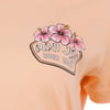 Peach-colored shirt with Ron Jon Surf Shop logo and pink hibiscus flowers printed on the chest.