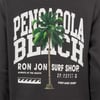 Black shirt featuring Pensacola Beach text, a palm tree graphic, Ron Jon Surf Shop, coordinates, a wave icon, and Vintage Surf in white lettering.