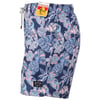 Blue swim shorts with a floral and bird pattern, featuring pink and white flowers and blue leaves. A tag and a patch label are attached.