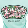 Back of a mint shirt featuring a Ron Jon Surf Shop Myrtle Beach logo with pink hibiscus flowers.