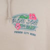 Close-up of a beige sweatshirt with Ron Jon Surf Shop and Panama City Beach printed, featuring floral designs and a drawstring.