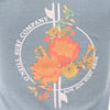 A graphic design featuring orange and yellow flowers with two vertical surfboards, surrounded by the text O'Neill Surf Company and Ron Jon Surf Shop on a gray background.