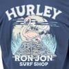 T-shirt with HURLEY and RON JON SURF SHOP text, featuring a flamingo on a boardwalk, surrounded by water and grass, with a moon and clouds in the background.