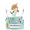 A snow globe with a mermaid figurine inside, decorated with seashells and starfish on the base labeled Ron Jon Surf Shop.