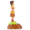 Plastic hula dancer figurine standing on a brown base with green accents, wearing a grass skirt and flower accessories, shown in profile view.