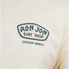 Close-up of a Ron Jon Surf Shop logo on a light-colored fabric, with the text Cocoa Beach underneath.