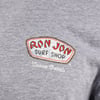Close-up of a gray shirt featuring the Ron Jon Surf Shop logo and Cocoa Beach text.