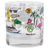 Clear glass with colorful illustrations: ship, turtle, palm trees, mermaid, flamingo, sunglasses, surfboard, fish, and croissant. Labeled Wanderer Collection.