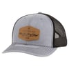 Gray and black trucker hat with a brown leather patch displaying Ron Jon Surf Shop and Established 1959.