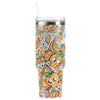A tall tumbler with a clear lid and straw, decorated with orange fruit slices, white flowers, and cartoon skulls in an orange, white, and black color scheme.