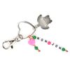A keychain with a heart-shaped ring, green and pink beads, and white letter beads spelling RON JON. A metal turtle charm is attached and a lobster clasp.