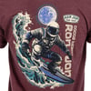 Illustration on a T-shirt of an astronaut surfing a wave with the moon in the background. Text reads Ron Jon Surf Shop and Cocoa Beach.