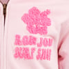 Close-up of a light pink garment with textured pink floral emblem and fuzzy text reading RON JON SURF SHOP.
