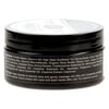 Black cylindrical container with a list of skincare product ingredients on the label.