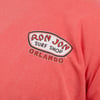 Close-up of a watermelon colored t-shirt featuring the Ron Jon Surf Shop Orlando logo printed on the chest.