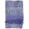 A folded lavender fabric with light green leaf and vine patterns, featuring a tasseled fringe on one end.