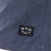 Close-up of a dark blue fabric with a black patch labeled Ron Jon Surf Shop featuring a palm tree graphic.