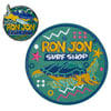 Round embroidered patch and enamel pin, both featuring Ron Jon Surf Shop text and a sea turtle illustration with colorful geometric accents.