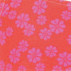 Red fabric with a pattern of pink, six-petaled flowers evenly distributed across the surface.