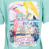 Back of a mint Ron Jon Surf Shop t-shirt featuring a lifeguard chair with a dog sitting on it, a surfboard, and a beach scene with a sailboat and Orlando written at the bottom.