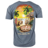 Gray blue t-shirt featuring a colorful beach scene with a surfboard, wooden car, palm trees, and a hut. Text reads: “The Good Life,” “Ron Jon Surf Shop,” and “Cocoa Beach, Fla.”.