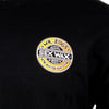 A black shirt with a circular yellow, orange, and white Mr. Zogs Sex Wax logo printed on the chest.