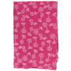 A piece of pink fabric featuring a white palm tree pattern scattered across the surface.