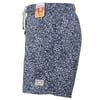 Navy blue swim trunks with a white floral pattern, elastic waistband with drawstring, and a rectangular label near the hem.