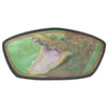 A sticker shows the image of an alligator with its mouth open wide, revealing sharp teeth.