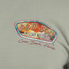 The image shows a close-up of a t-shirt logo that reads Ron Jon Surf Shop on a colorful badge, with Cocoa Beach, Florida written below in red script.